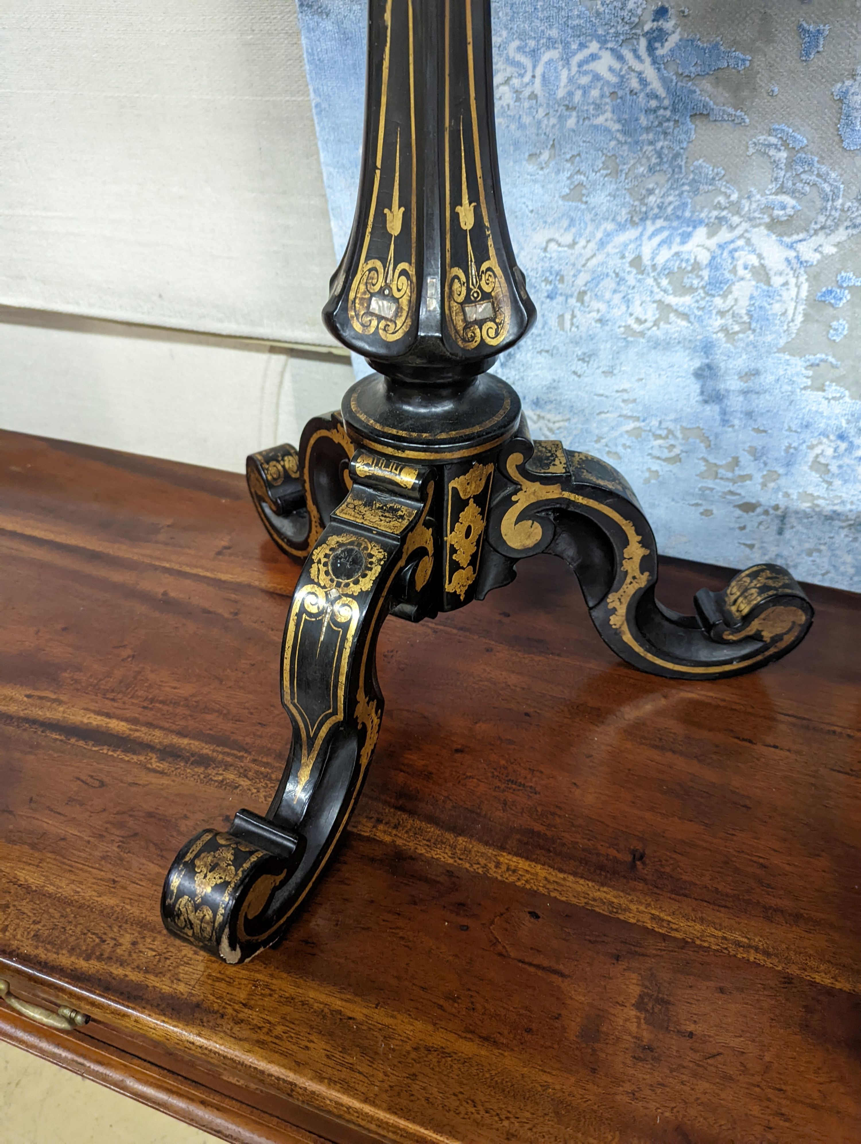 A Victorian mother of pearl inlaid gilt decorated circular tilt top papier mache tripod wine table, diameter 51cm, height 74cm